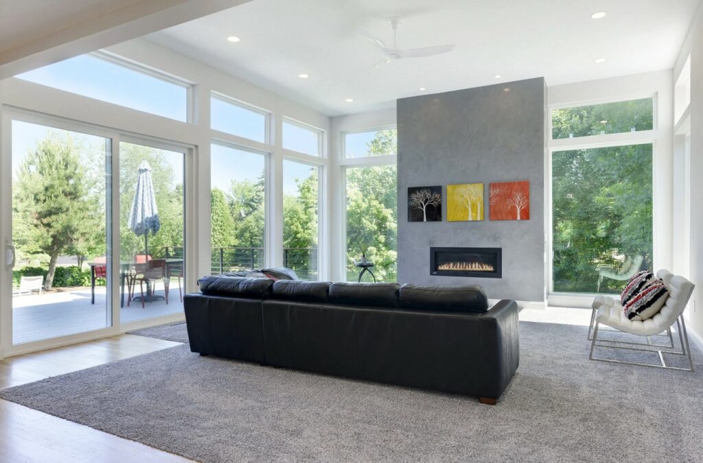 A Cozy Living Room with a Fireplace and Expansive Windows