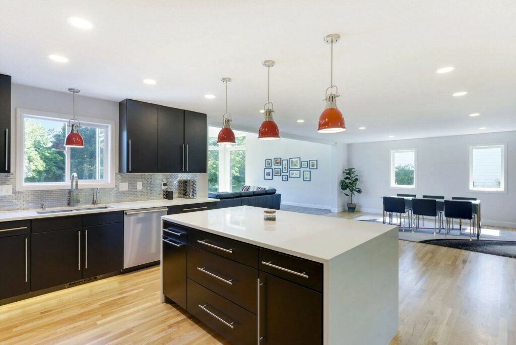 A Kitchen with Sleek Black Cabinets and Pristine White Counter Tops