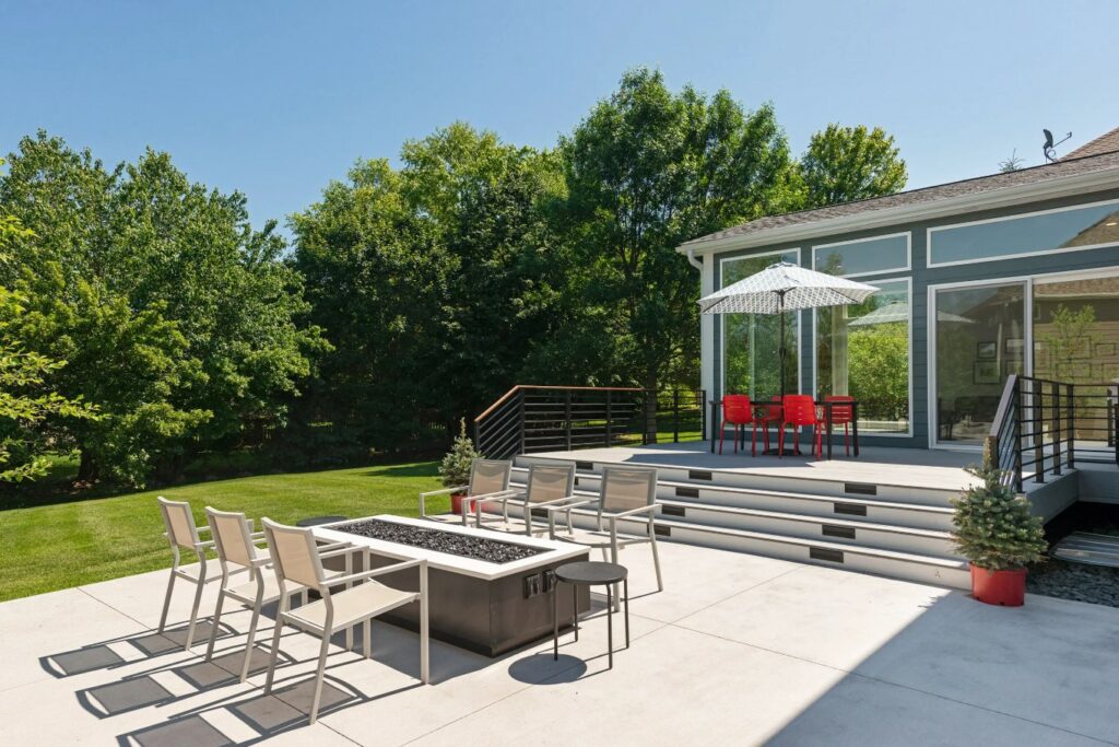 A Serene Patio with Comfortable Chairs and a Colorful Umbrella Providing Shade